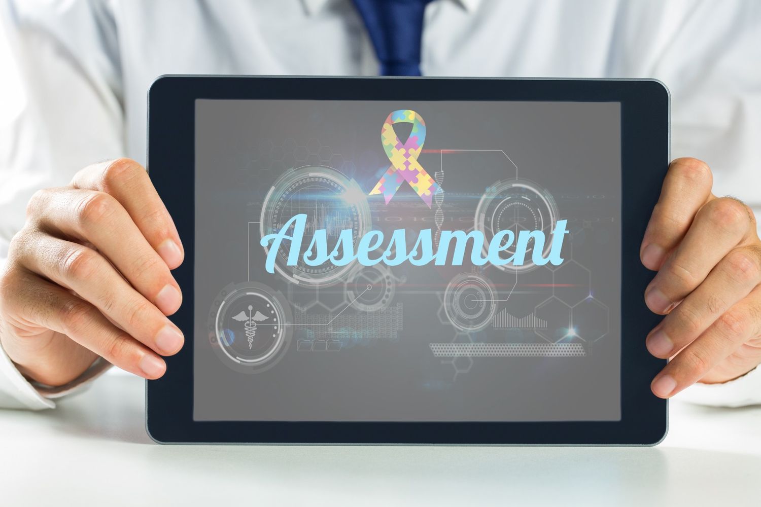 Autism assessment concept shown on a tablet screen with puzzle ribbon symbol, representing early evaluation and support.